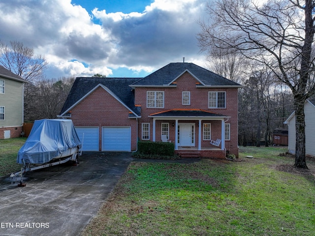 view of front facade with a garage, covered porch, and a front lawn