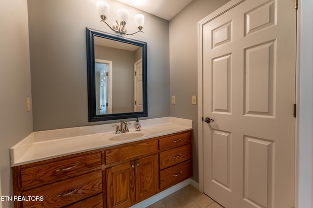 bathroom featuring tile patterned floors, vanity, and a notable chandelier