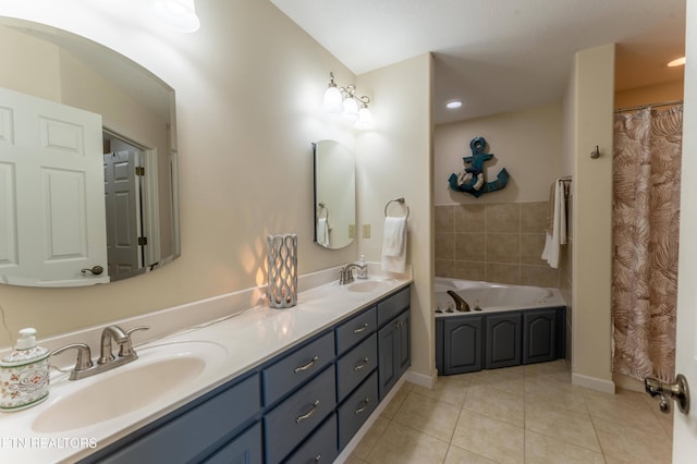 bathroom with a bathing tub, tile patterned flooring, and vanity