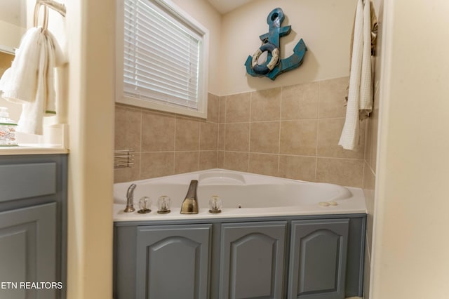 bathroom featuring vanity and a bath