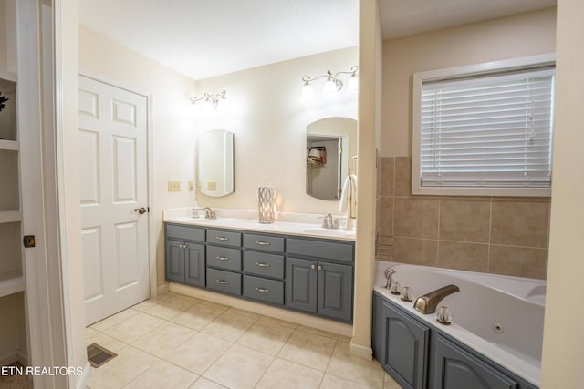 bathroom with a bathing tub, tile patterned flooring, and vanity