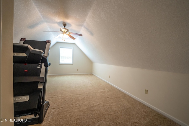 additional living space with carpet, ceiling fan, a textured ceiling, and vaulted ceiling