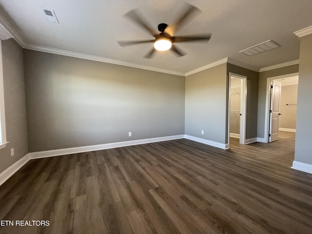 interior space with a textured ceiling, ceiling fan, dark hardwood / wood-style floors, and ornamental molding