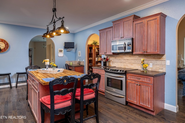 kitchen with pendant lighting, crown molding, decorative backsplash, appliances with stainless steel finishes, and dark hardwood / wood-style flooring