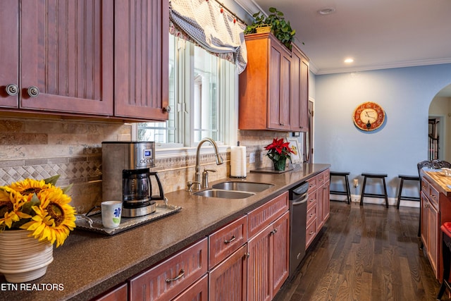 kitchen featuring crown molding, sink, stainless steel dishwasher, dark hardwood / wood-style floors, and tasteful backsplash