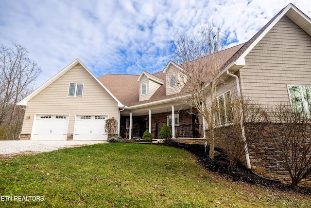 view of front facade with a porch, a garage, and a front yard