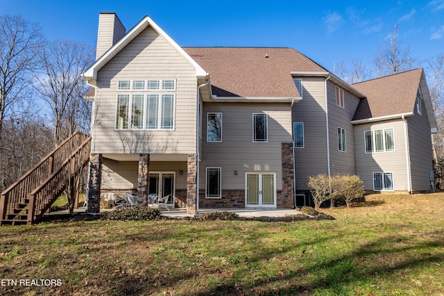 rear view of property featuring a lawn, a patio area, and central air condition unit