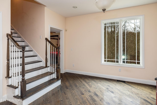 staircase with hardwood / wood-style flooring