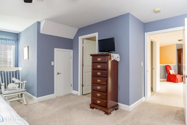 carpeted bedroom with lofted ceiling