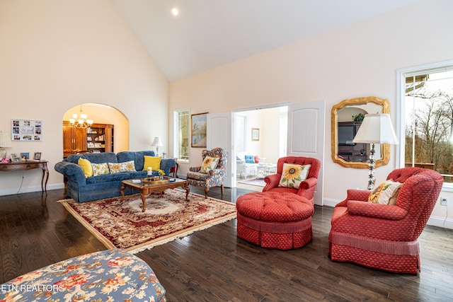 living room with hardwood / wood-style flooring, high vaulted ceiling, and an inviting chandelier