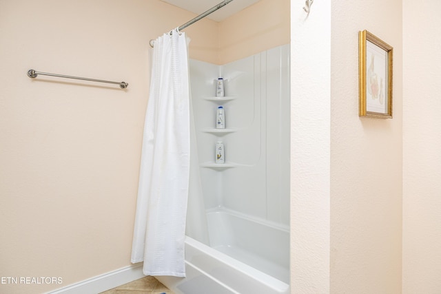 bathroom featuring tile patterned flooring and shower / bathtub combination with curtain