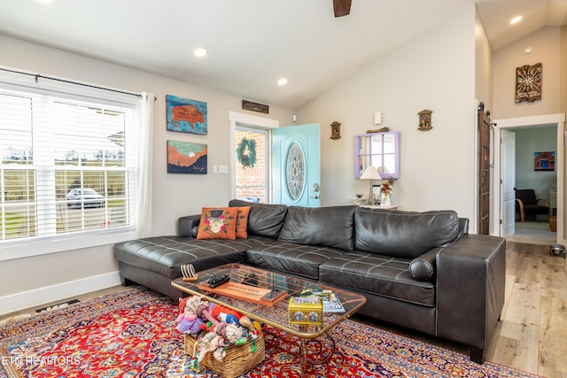 living room featuring light hardwood / wood-style flooring and vaulted ceiling