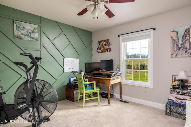 carpeted office featuring ceiling fan