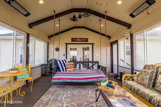 sunroom / solarium with lofted ceiling with beams, wooden ceiling, and french doors