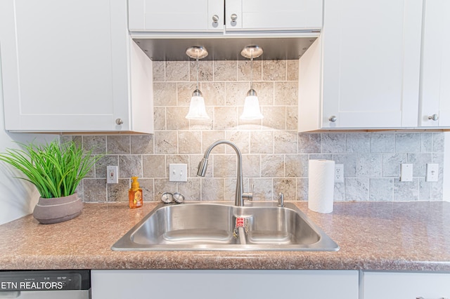 kitchen with decorative backsplash, white cabinetry, and sink