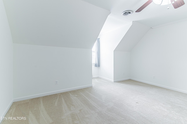 additional living space with ceiling fan, light carpet, and vaulted ceiling