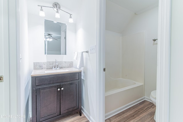 bathroom with ceiling fan, toilet, hardwood / wood-style flooring, vanity, and ornamental molding