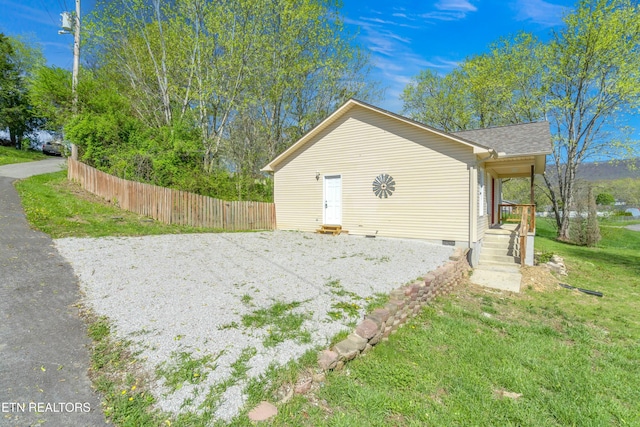 view of side of home featuring a lawn