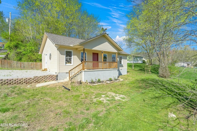 view of front of house with a front yard and a porch