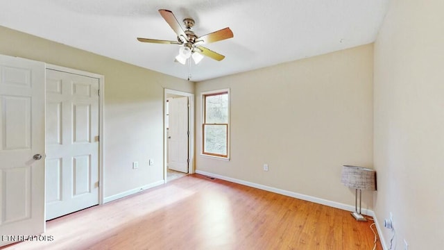 unfurnished bedroom featuring light wood-type flooring and ceiling fan