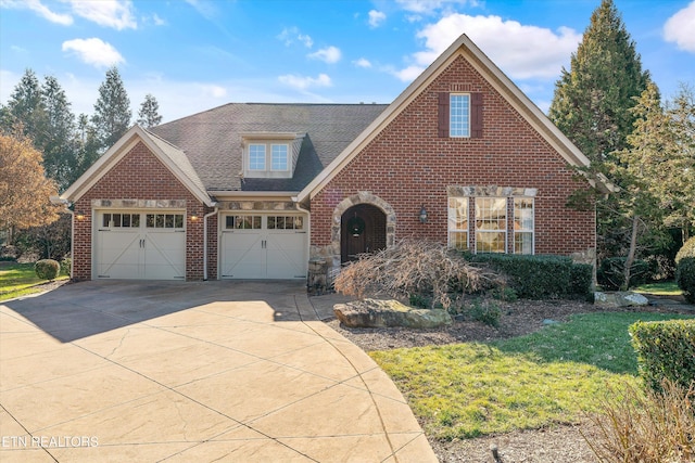 front facade with a garage and a front lawn