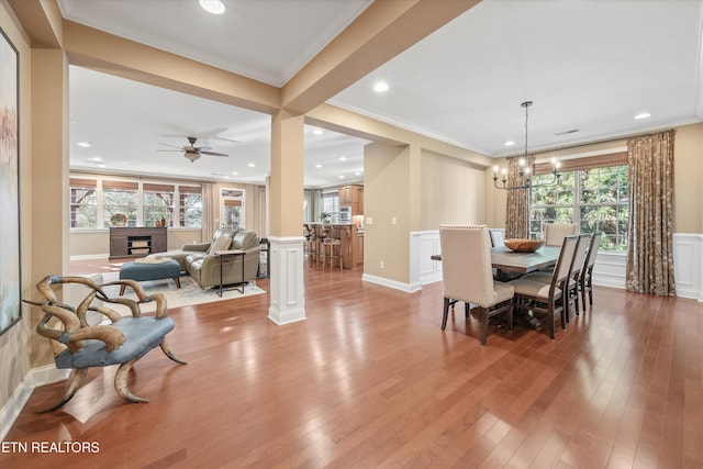 dining space featuring ornamental molding, light hardwood / wood-style flooring, and a wealth of natural light