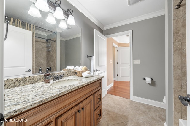 bathroom featuring tiled shower, toilet, ornamental molding, vanity, and tile patterned flooring