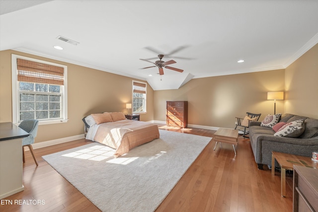 bedroom with hardwood / wood-style flooring, crown molding, vaulted ceiling, and ceiling fan