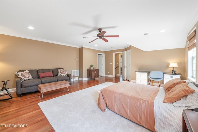 bedroom with ceiling fan, ornamental molding, and light hardwood / wood-style floors