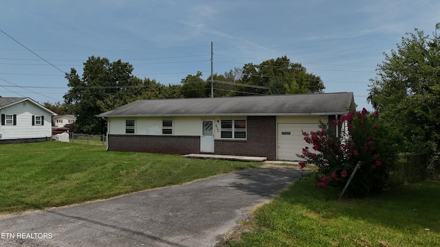 ranch-style house with a front yard and a garage