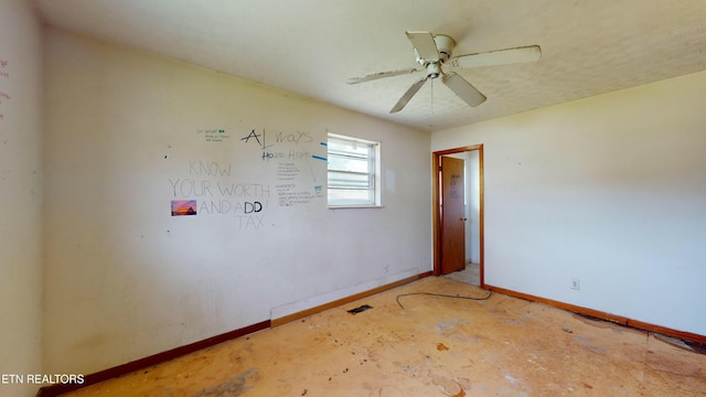 empty room with concrete flooring and ceiling fan