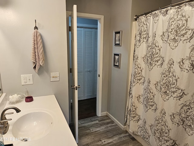 bathroom featuring wood-type flooring and sink