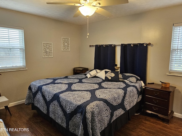 bedroom with ceiling fan and dark wood-type flooring