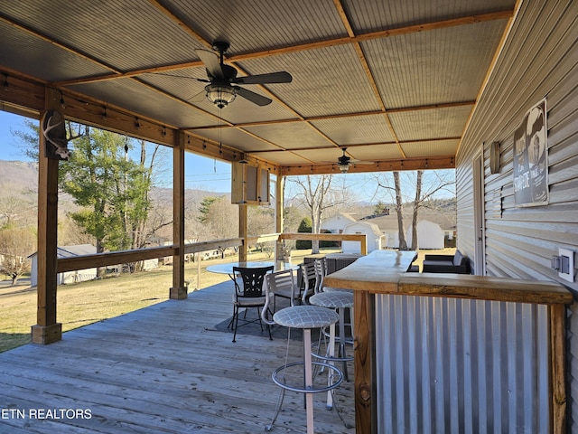 deck featuring a ceiling fan and outdoor dry bar