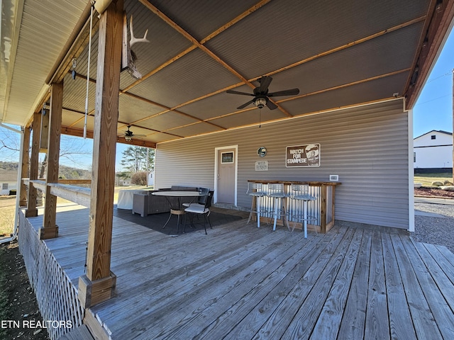 deck featuring a jacuzzi, outdoor dry bar, and a ceiling fan