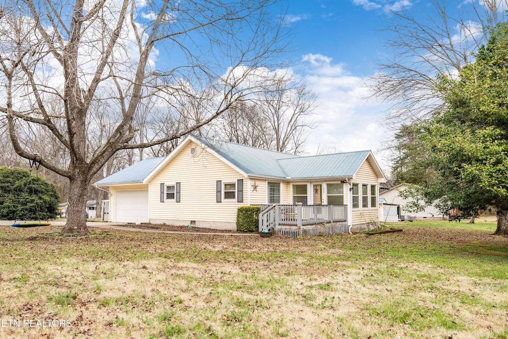 view of front of home featuring a porch, a garage, and a front yard