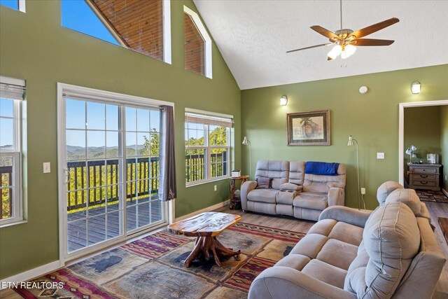 living room with hardwood / wood-style floors, ceiling fan, and a wealth of natural light