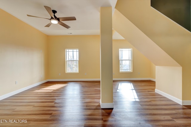 additional living space with light hardwood / wood-style floors and ceiling fan