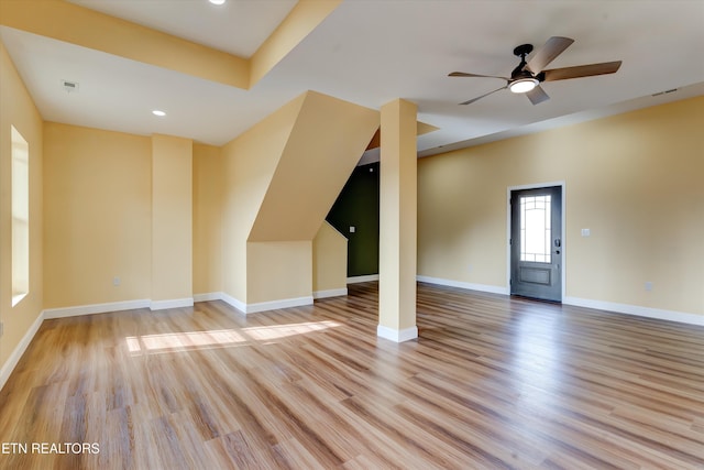 unfurnished living room featuring ceiling fan and light wood-type flooring