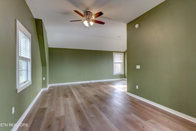 unfurnished room featuring light hardwood / wood-style floors, ceiling fan, and lofted ceiling