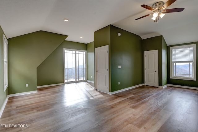 additional living space featuring ceiling fan, lofted ceiling, and light wood-type flooring