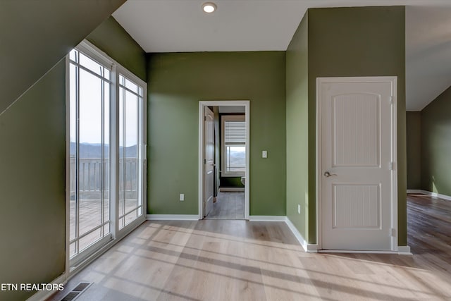 interior space with a mountain view and light wood-type flooring