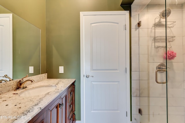 bathroom featuring vanity and an enclosed shower