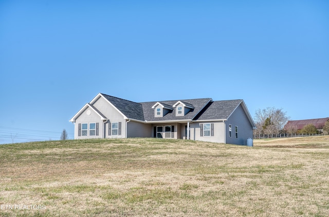 new england style home featuring a front lawn