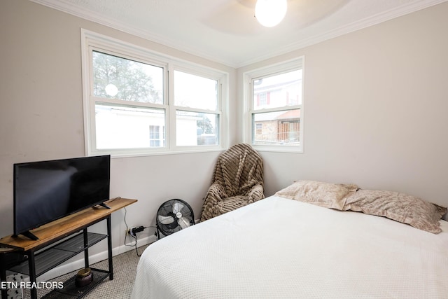 carpeted bedroom featuring ceiling fan and ornamental molding