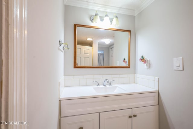 bathroom featuring vanity, ornamental molding, and a textured ceiling