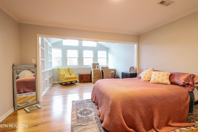 bedroom with light hardwood / wood-style flooring and ornamental molding