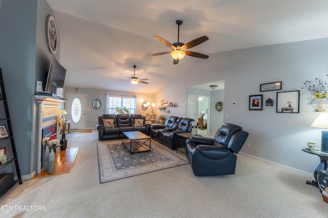 living room with carpet, ceiling fan, lofted ceiling, and a tile fireplace