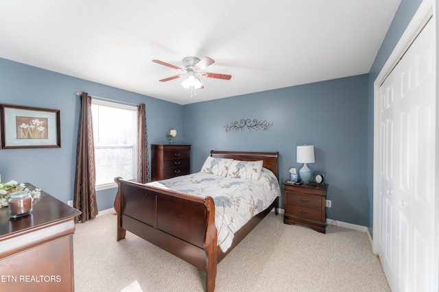 bedroom with light carpet, a closet, and ceiling fan