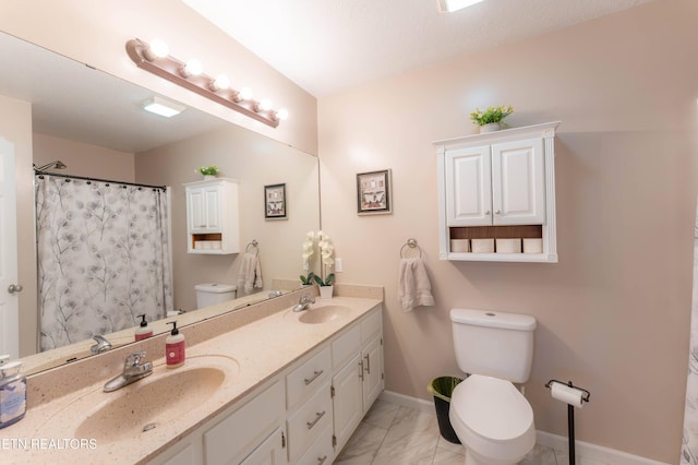 bathroom with curtained shower, vanity, a textured ceiling, and toilet